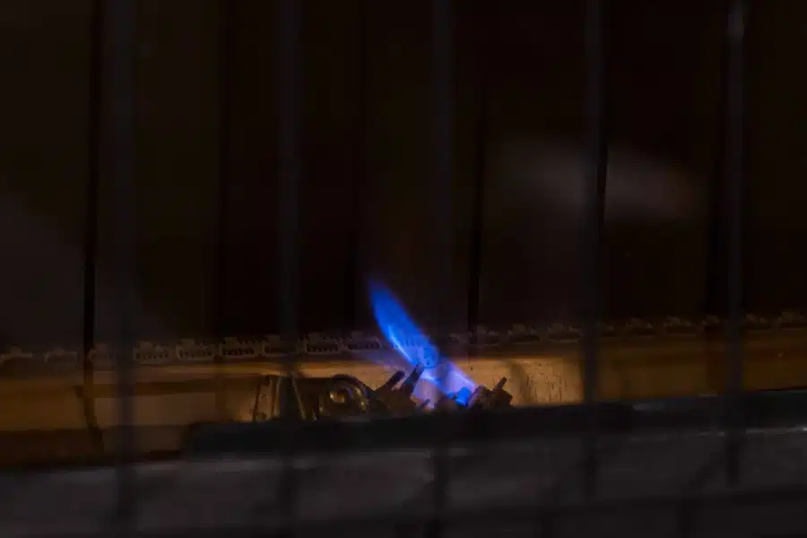 A pilot light igniting a gas furnace.