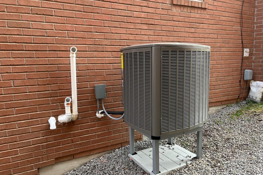 A heat pump outside of a house.