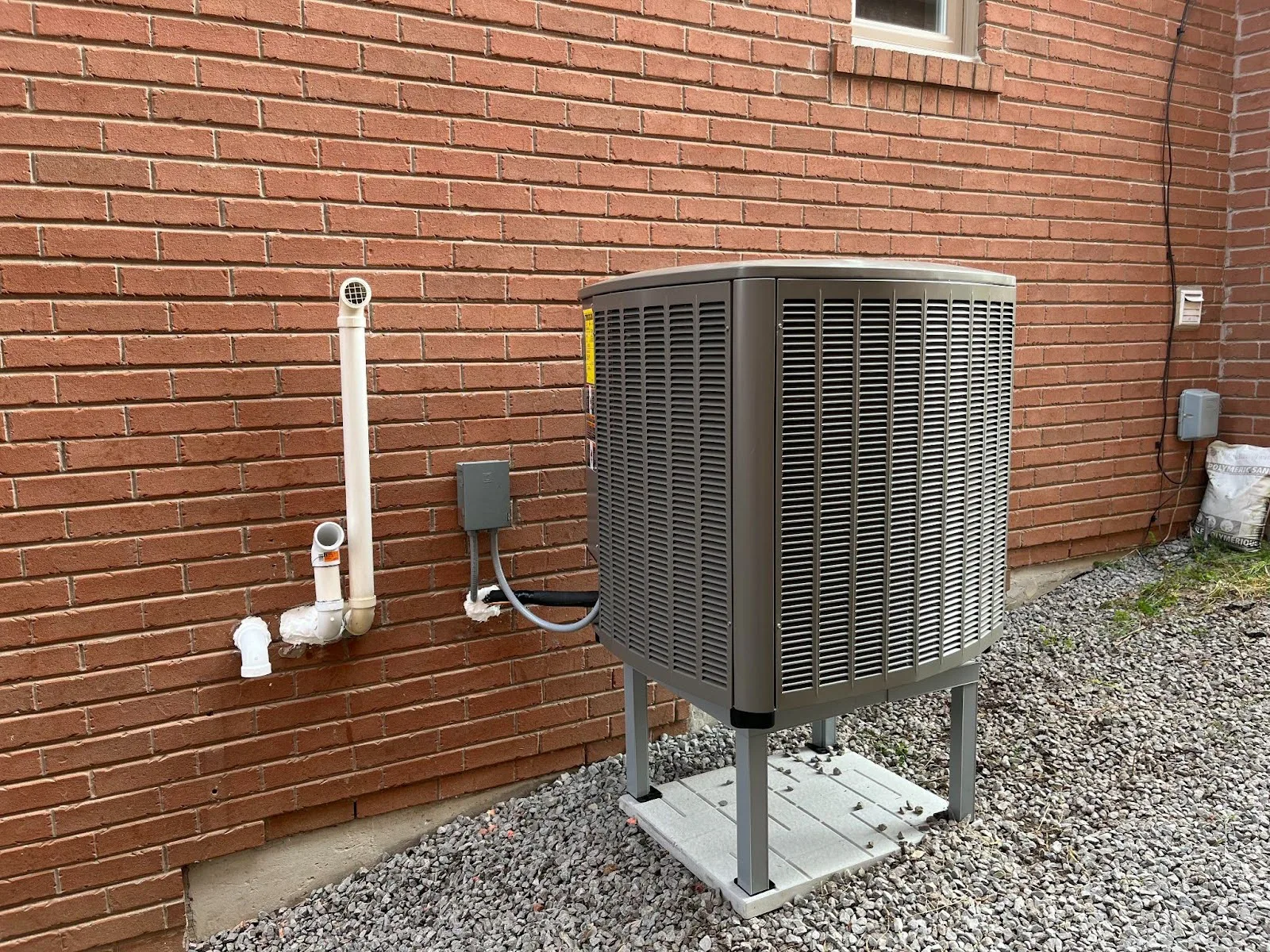 A heat pump outside of a house.
