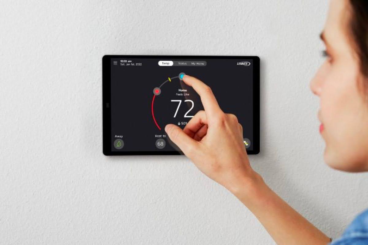 A person adjusting the Lennox S40 smart thermostat.