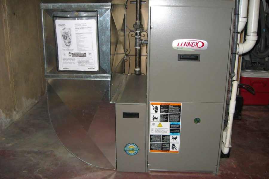 A picture of a Lennox gas furnace in a basement.