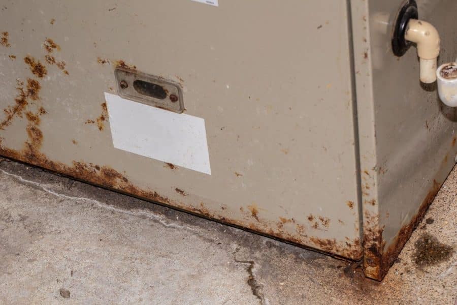 An old furnace with rust that needs to be replaced.