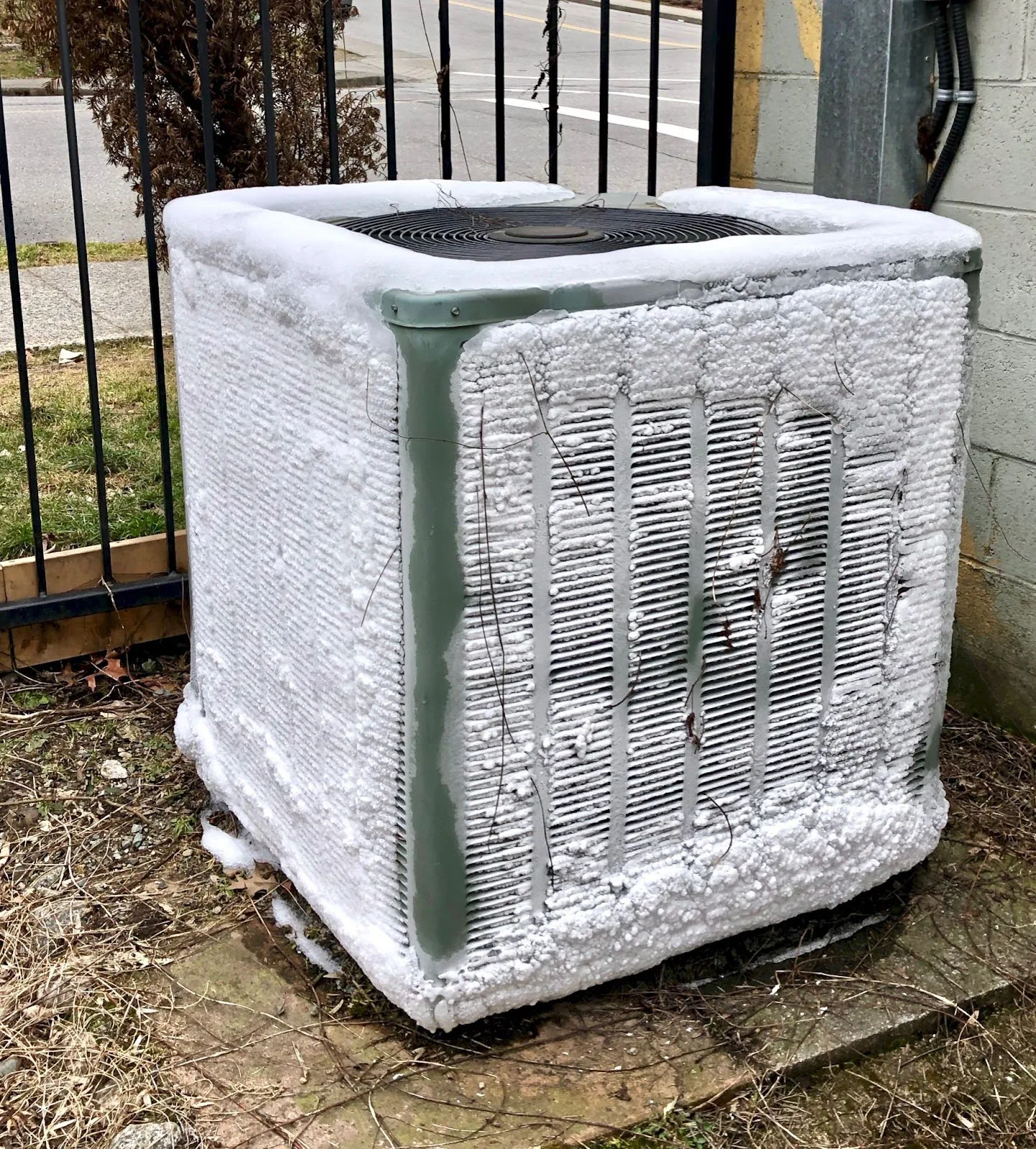An outside AC unit with ice buildups.