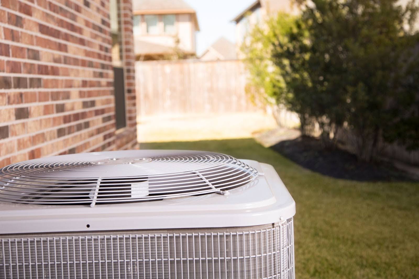 An outside AC unit in warm and dry weather.